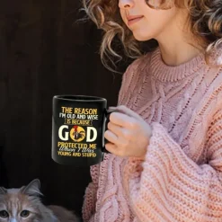 Funny Coffee Mug - The Reason I'm Old and Wise Is Because God Protected Me, Black Ceramic 11oz Cup, Sarcastic Gift for Dad, Grandpa, Friends, and Coworkers